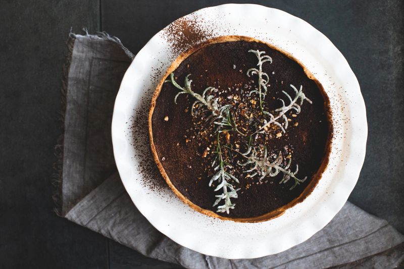 Vegan-licious chocolate and nuts torte topped with frosted rosemary branches.