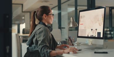 Woman working on a computer in an office.