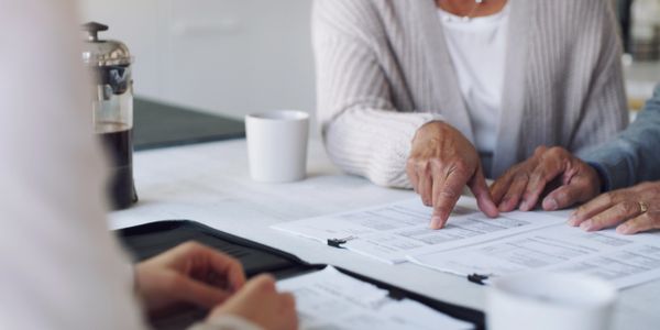 Woman reviewing health insurance benefits while having coffee.