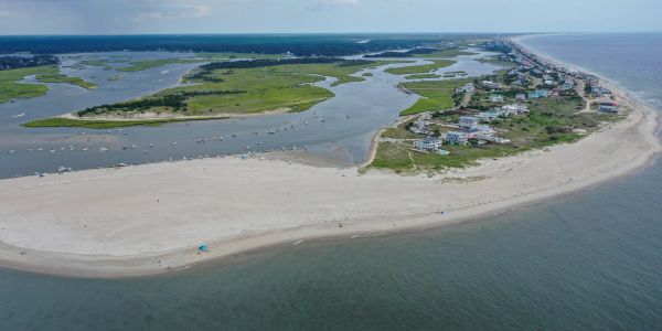Aerial view of a coastal town with sandy beaches and waterways.