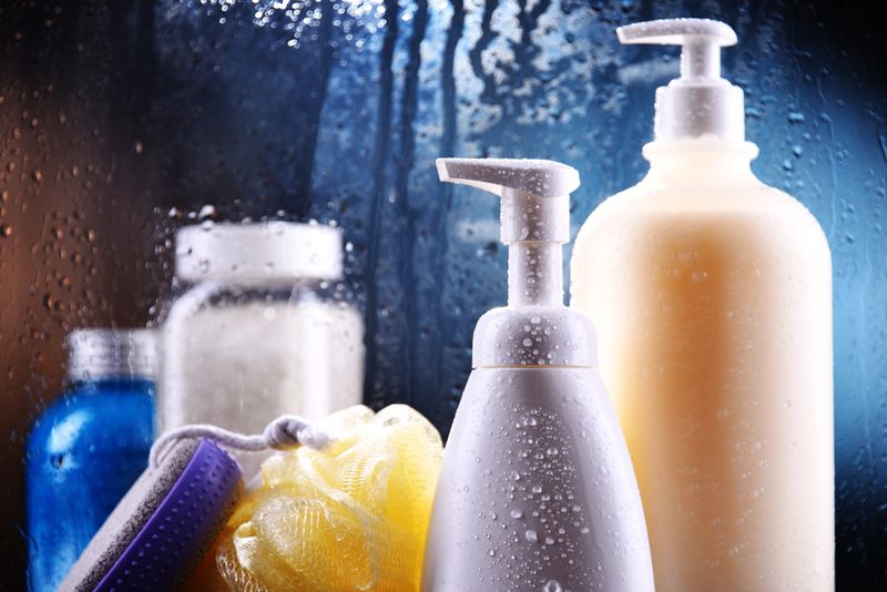 Different containers of body care products in the bathroom.