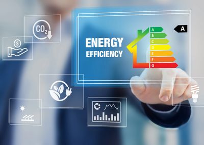 Hand pointing at an energy efficiency rating chart with icons for sustainability and cost savings.