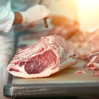 Raw beef ribeye on a cutting board.