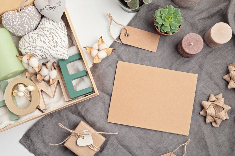 Preparing care package, seasonal gift box with candles, succulent, interior scent. Personalized eco friendly basket for family and friends for thankgiving, christmas, mothers day holidays.