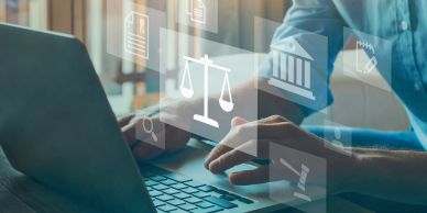 Person using laptop with legal icons overlay.