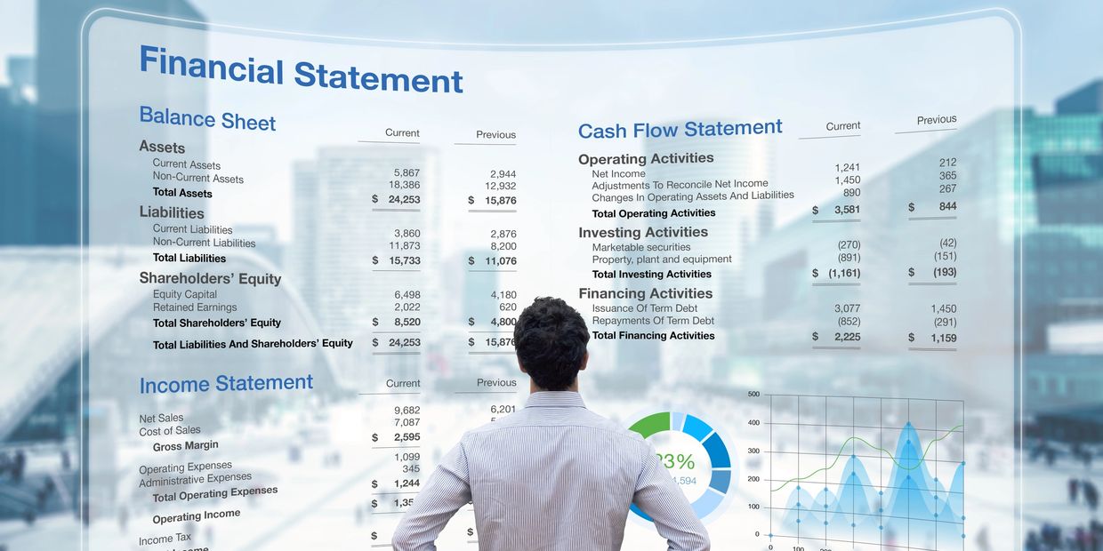 A man analyzes financial statements and charts on a transparent screen.