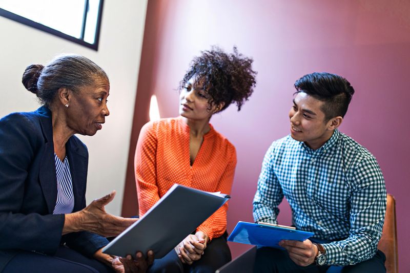 Couple getting a consultation with a senior female consultant.
