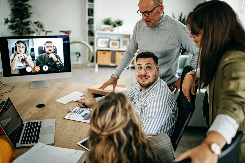 Group of business people having video meeting with customer