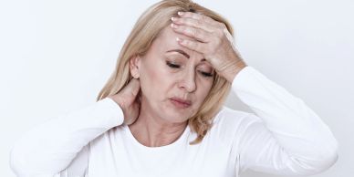 Woman experiencing headache and neck pain.