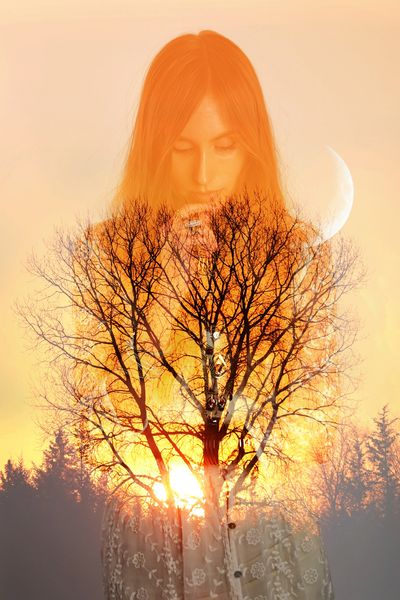 Double exposure of a woman and a tree at sunset.