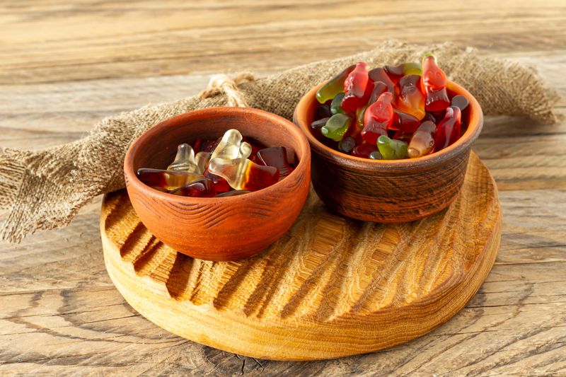 colorful candy and jelly sweet, jelly candy flavor fruit, candy dessert in clay bowls in wooden tray. rustic style