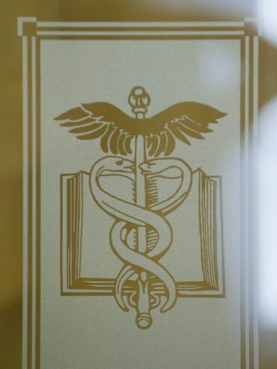 Medical symbol with snakes and a winged staff.