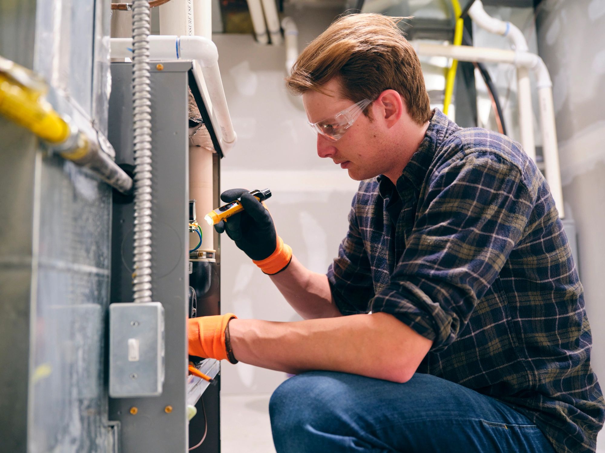 HVAC technician performing a furnace tune-up in a Calgary home