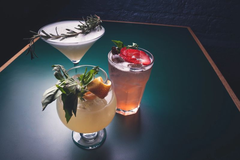 Dark photography of colorful mixology. Alcoholic cocktails. Fruit mixology. Concept of bar