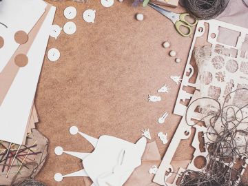 Crafting materials arranged on a brown surface.