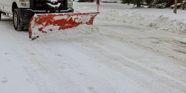 Snowplow clearing snow from road.