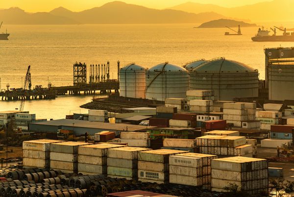 Rows of industrial battery containers at sunset.