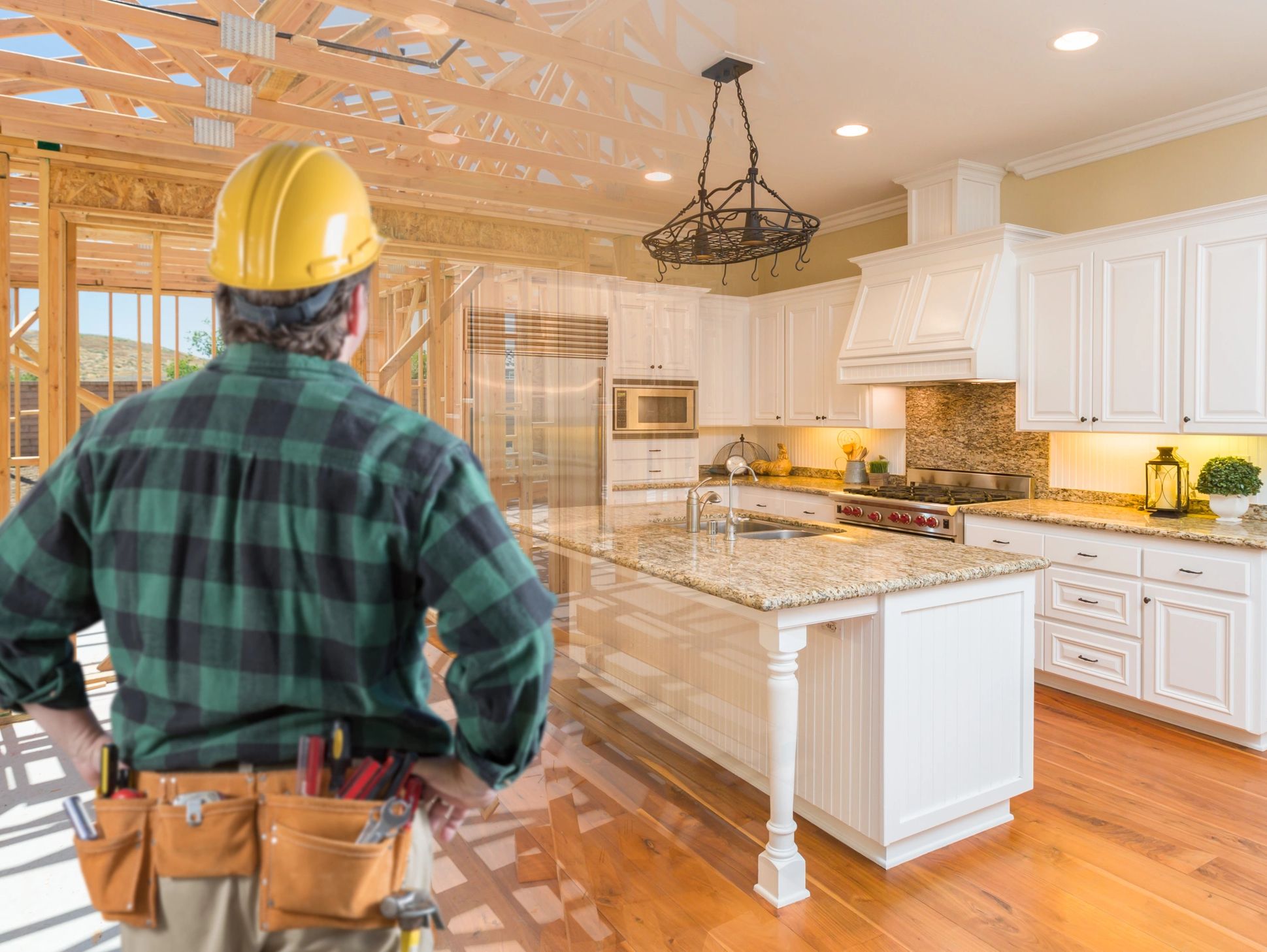 Construction worker envisions a finished kitchen inside a wooden house frame.