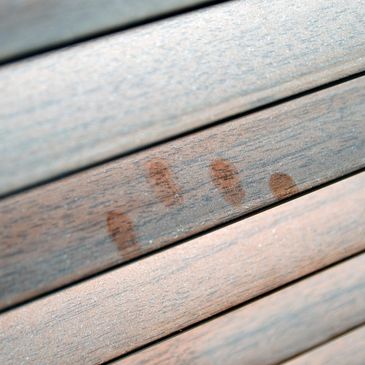 Wet handprint on wooden surface.