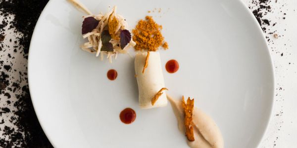 Gourmet dish with artistic plating on a white plate.