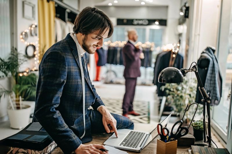 Suit salesman writing orders in his store
