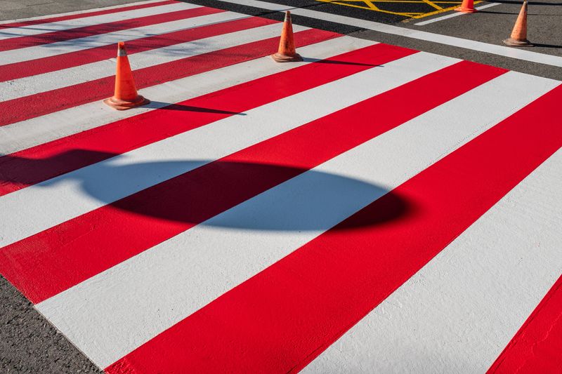 Road safety cones mark the area in which the crosswalks have been repainted. Road maintenance intervention in the city of Barcelona (Spain).