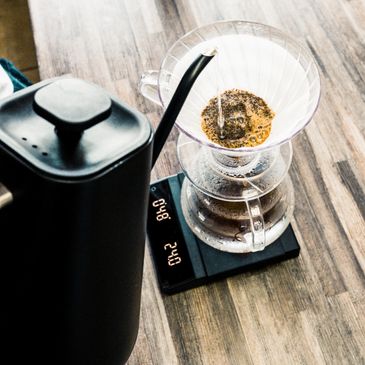 Pour-over coffee brewing setup on a wooden table.