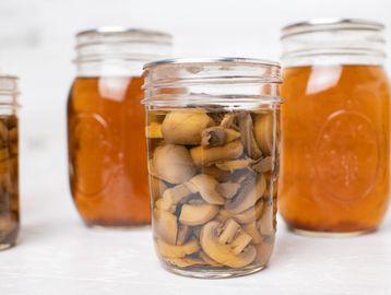 Jar of mushrooms fermenting in liquid