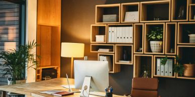 Modern office workspace with computer and plants.