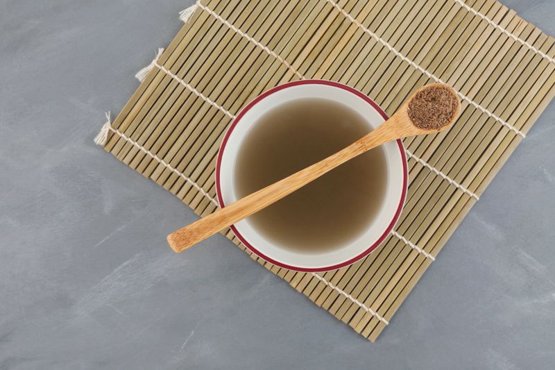 Herbal tea made from natural milk thistle powder or or Silybum marianum extract, top view. Healthy drink for aiding liver function.