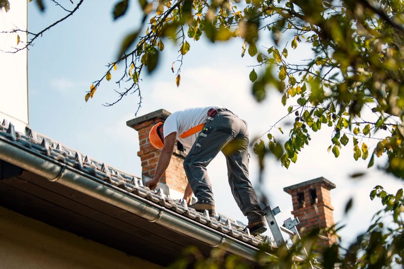 Professional construction worker  standing roof top and measuring chimney of new house under construction