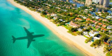 A aerial view of the sea with the shadow of airplane.