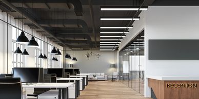 Modern open office with reception and workstations.