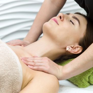 Woman receiving a shoulder massage in a spa.