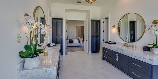 luxurious granite bathroom counter tops with high end sink and gold taps  