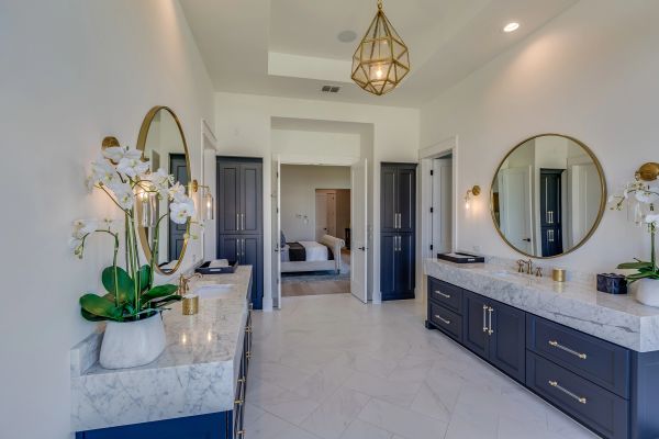 Elegant bathroom with dual vanities and round mirrors
