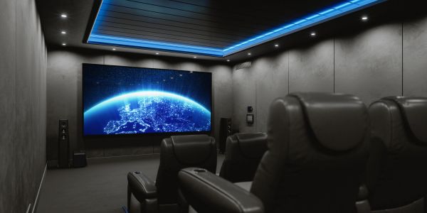 Modern home theater with dark walls and leather seats.