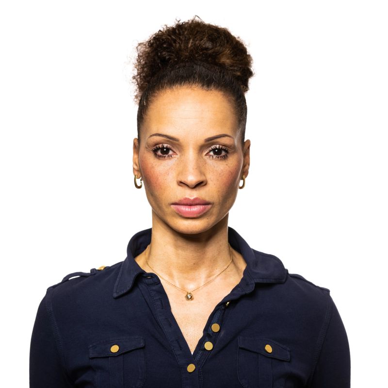 Portrait of a mid adult African woman staring at camera. African American woman against white background.
