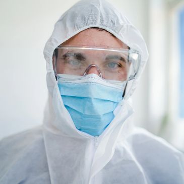 Healthcare worker in full protective gear with mask and goggles.