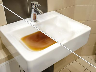 White ceramic sink with a modern faucet in a tiled bathroom.