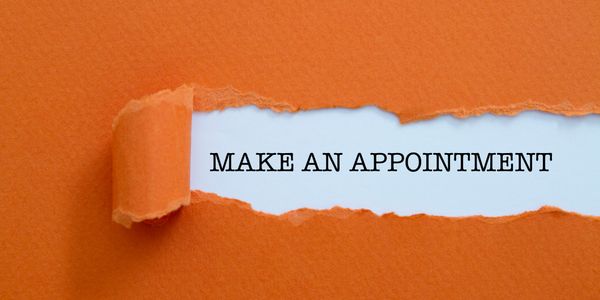 Text 'MAKE AN APPOINTMENT' revealed under torn orange paper.