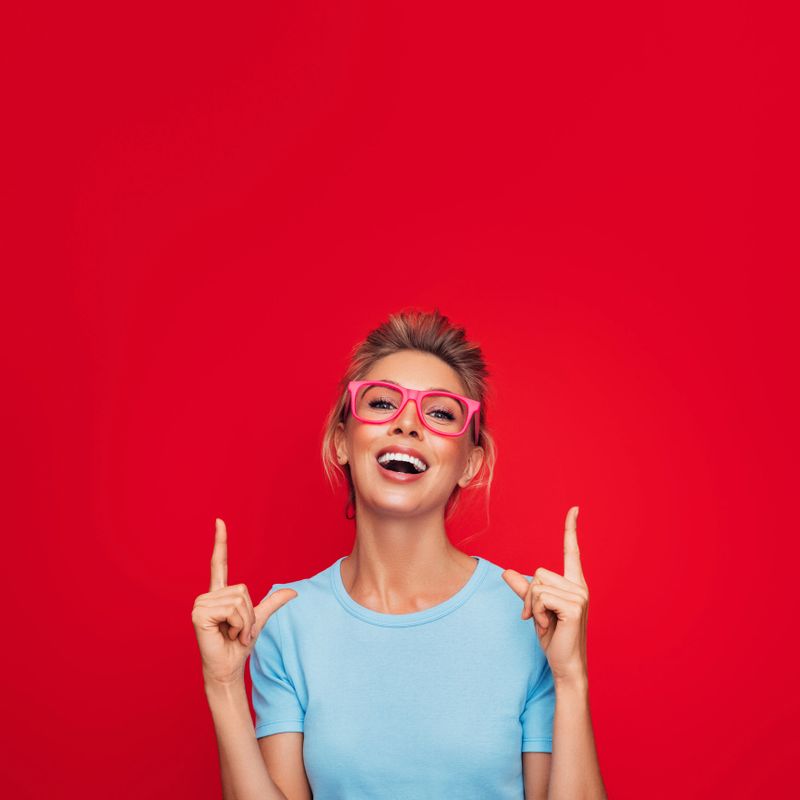 Close-up portrait of smiling woman presenting your product