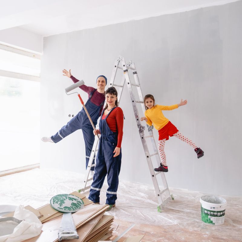family painting walls in their new house