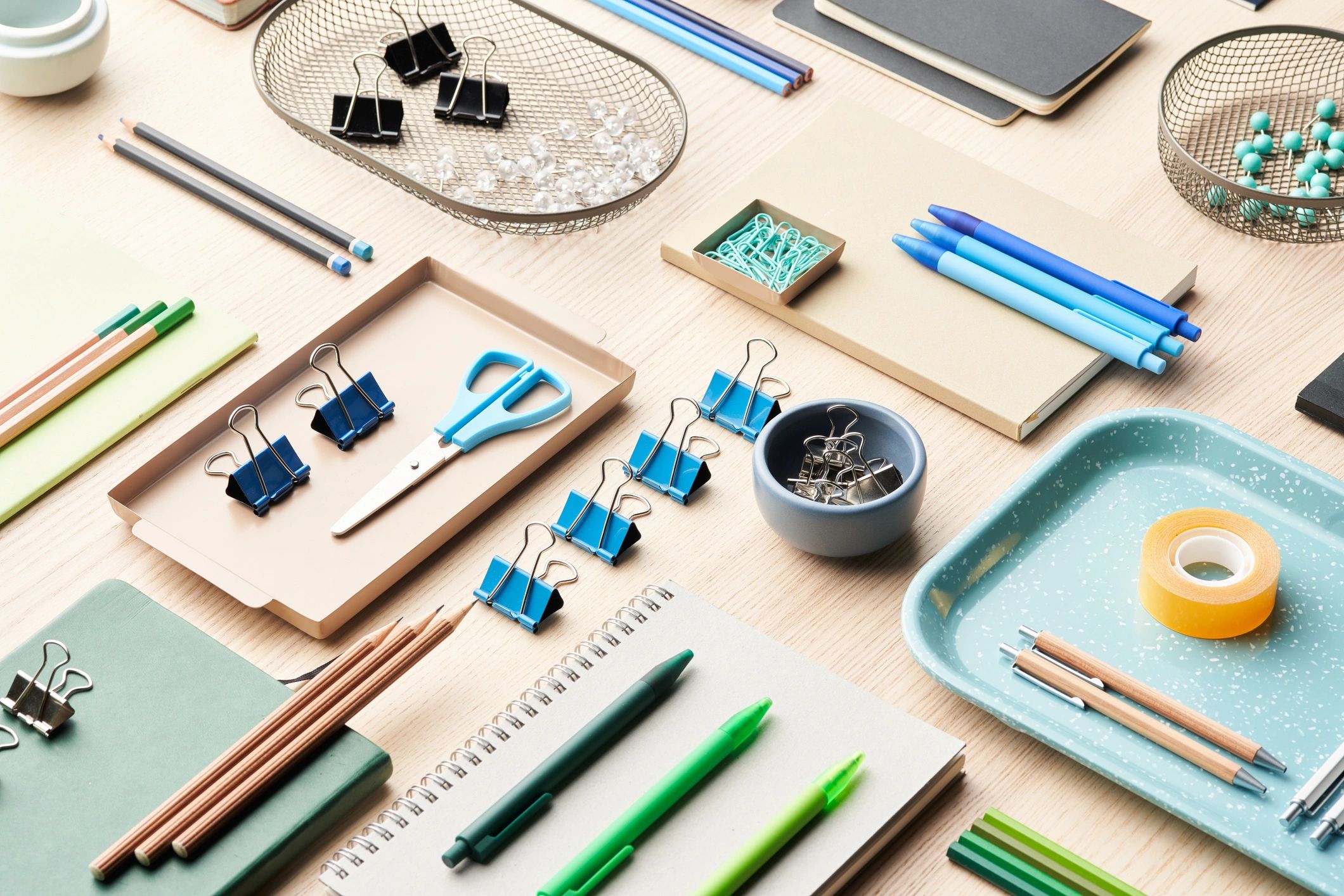 Organized desktop with stationery items including pencils, pens, clips, and tape.