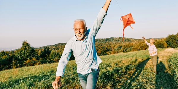 Older adults flying kites with joy