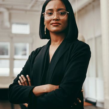     Confident female executive in a black business suit representing leadership, strategy, and profe