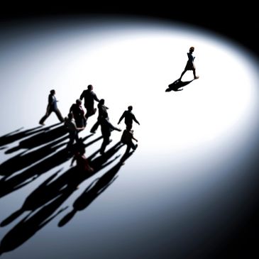 One person leading a group cast in a spotlight.