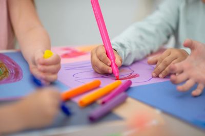 Children drawing with colorful markers.