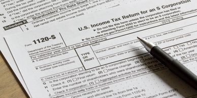 Close-up of a U.S. Income Tax Return form 1120-S with a pen on top.
