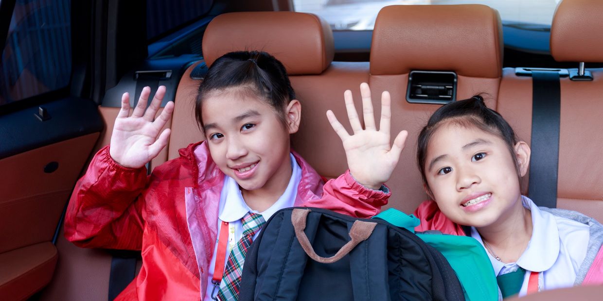 Kids being driven to school in  a private car. EverTrust is looking for drivers throuhgout PA